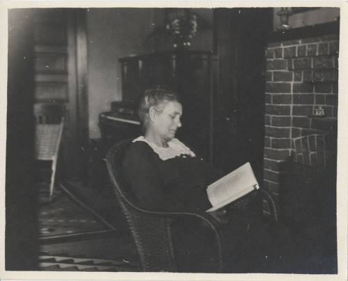 Woman Sitting by Fireplace Reading