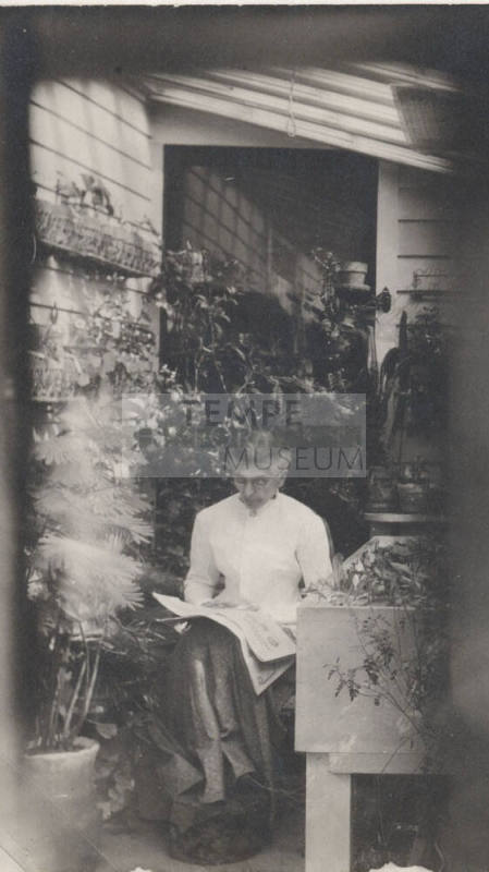 Sitting Woman Reading a Newspaper