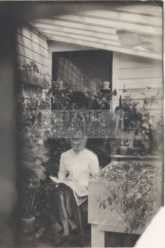 Sitting Woman Reading a Newspaper