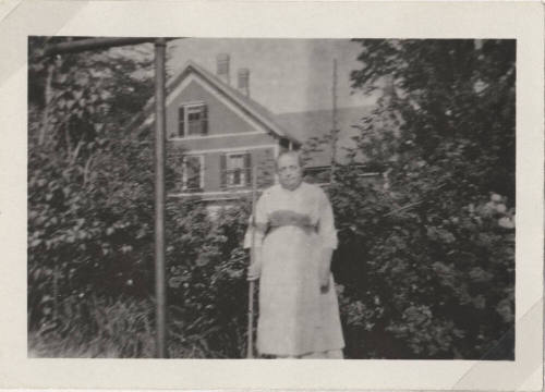 Woman Standing in Front of a House