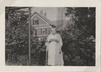 Woman Standing in Front of a House