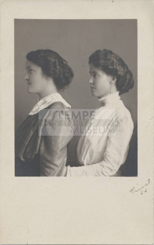Two Women Standing to the Side
