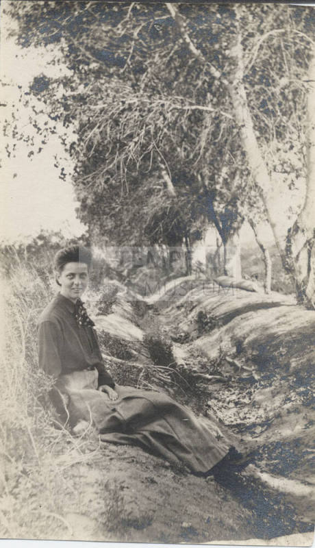 Woman Sitting Near a Group of Trees