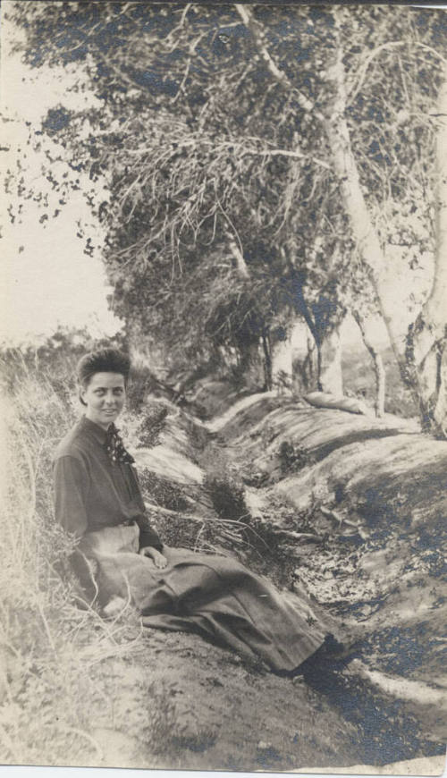 Woman Sitting Near a Group of Trees