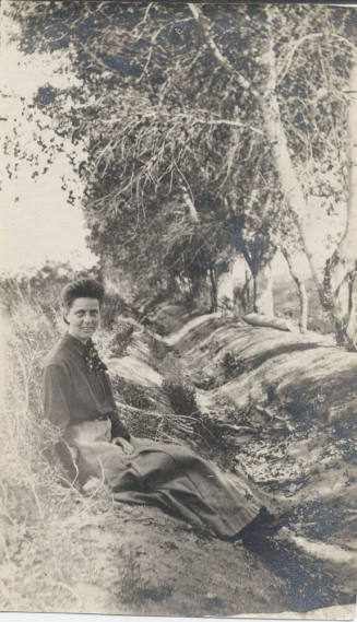 Woman Sitting Near a Group of Trees