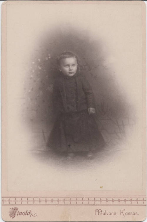 Sitting Child in Dark Clothing