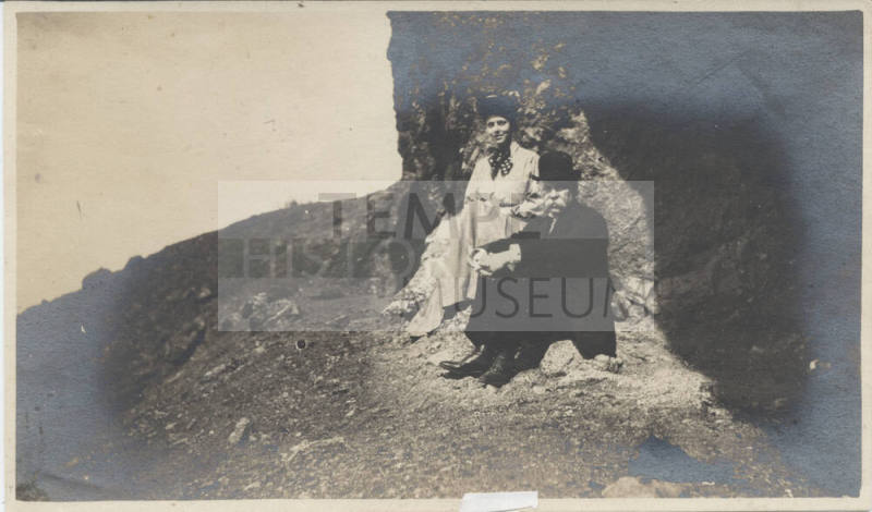 Unidentified Man and Woman Seated Outdoors