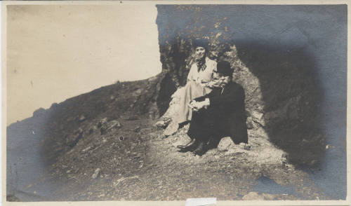 Unidentified Man and Woman Seated Outdoors