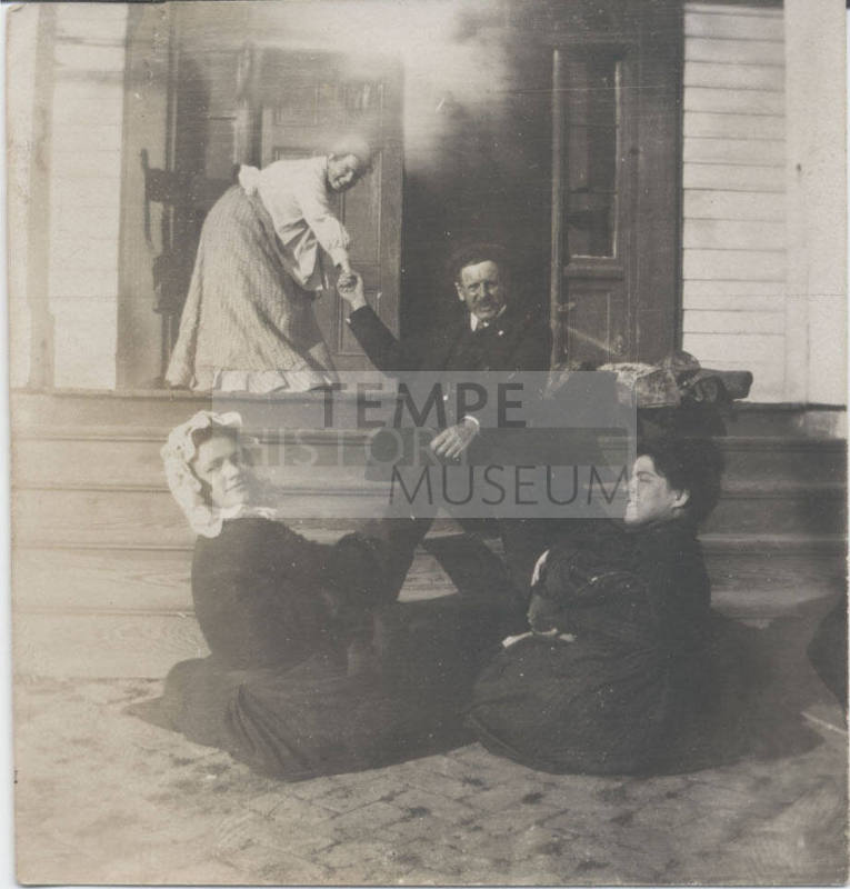 Group of People Seated on Porch