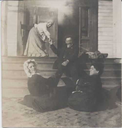 Group of People Seated on Porch