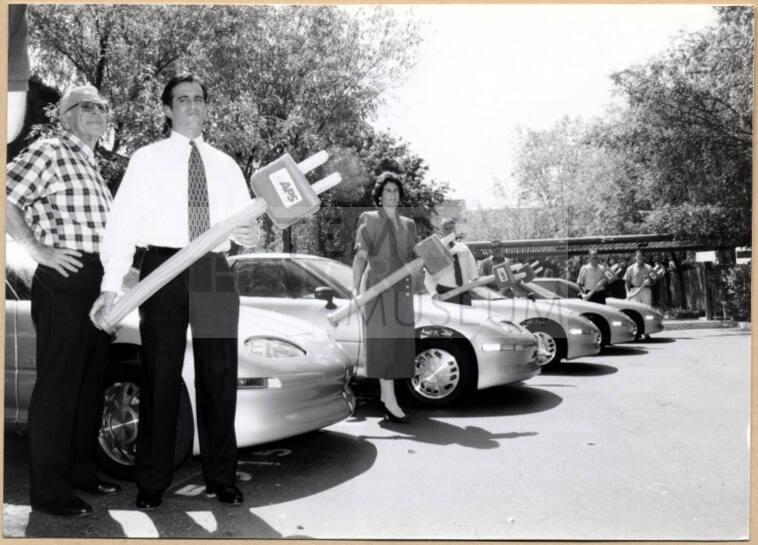 Black and white photograph of Niel Giuliano and other city employees at Tempe's electric vehicle debut