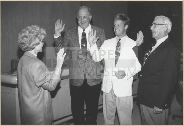 Black and white photograph of council members swearing