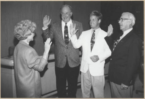Black and white photograph of council members swearing