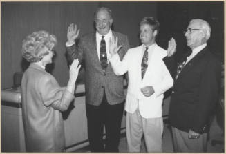 Black and white photograph of council members swearing