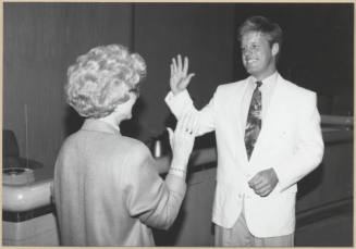 Black and white photograph of city clerk Helen Fowler swearing in council member Joseph Lewis