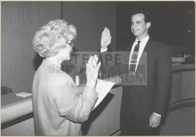 Black and white photograph of Mayor Niel Giuliano being sworn in by City Clerk Helen Fowler