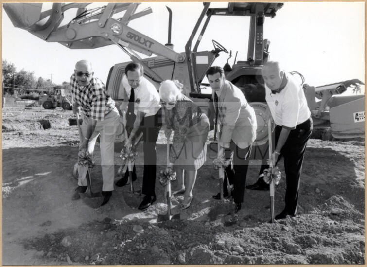 Black and white photograph of mayor and council members at fire station ground digging