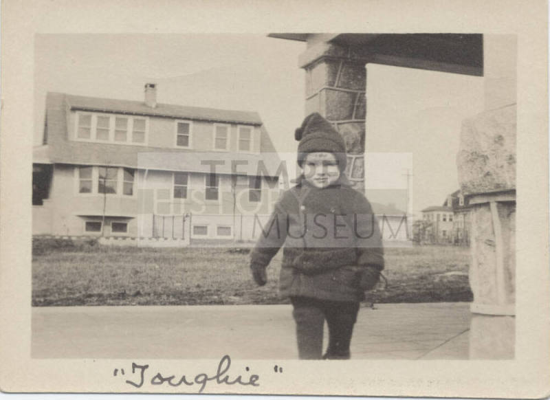 Picture of Small Boy in Front of House