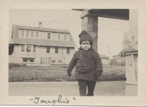 Picture of Small Boy in Front of House