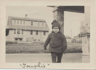 Picture of Small Boy in Front of House