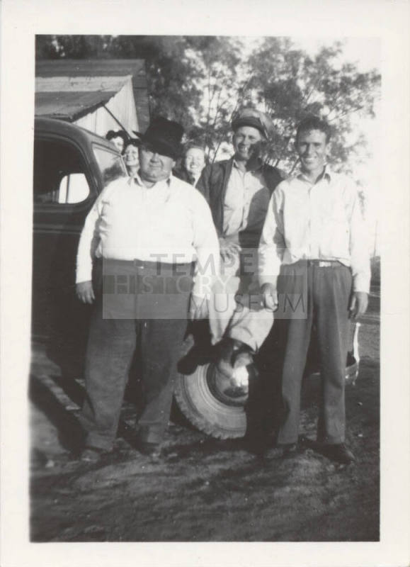 3 Men and 3 Ladies Standing by a Car