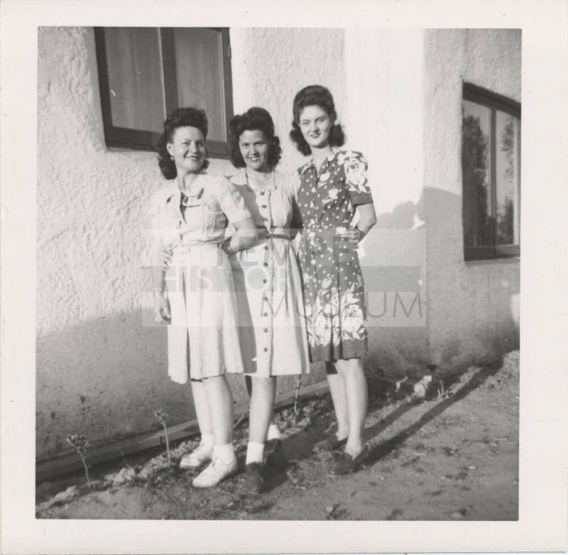Three Ladies Standing Near a House