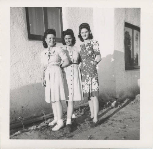 Three Ladies Standing Near a House