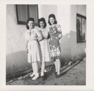 Three Ladies Standing Near a House