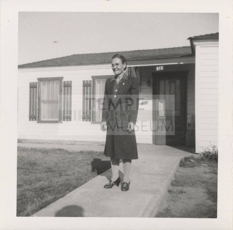A Lady Standing in Front of a Home