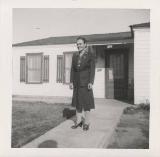 A Lady Standing in Front of a Home