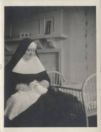 A Nun Holding a Baby