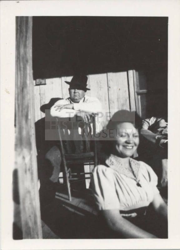 A Man and Woman Sitting in a Wood House