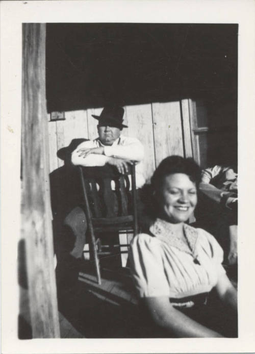 A Man and Woman Sitting in a Wood House