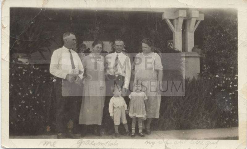 A Family Portrait in Front of a House