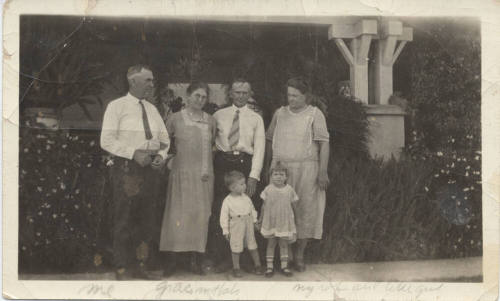 A Family Portrait in Front of a House