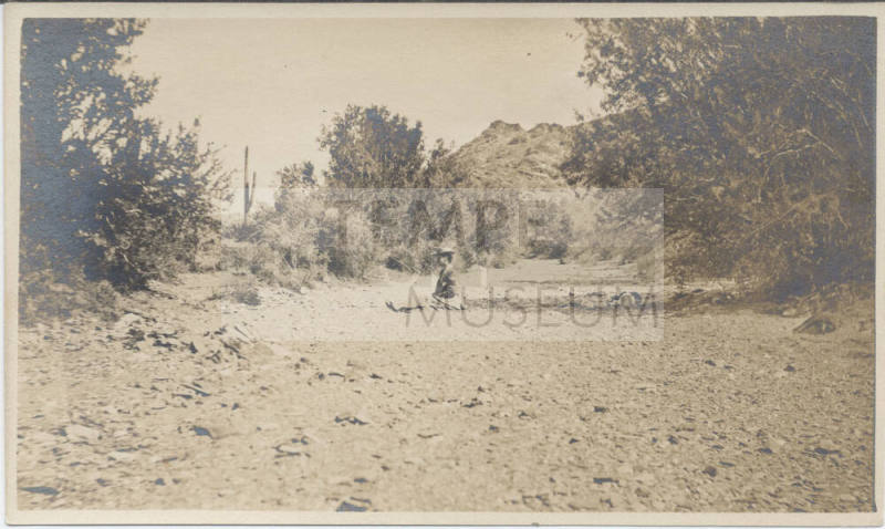 View of a Lady Sitting in a Dried Wash