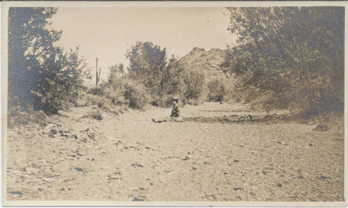 View of a Lady Sitting in a Dried Wash