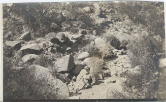 View of a Woman Sitting in the Desert