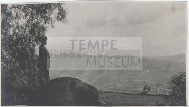Woman Looking at Aerial View of Town
