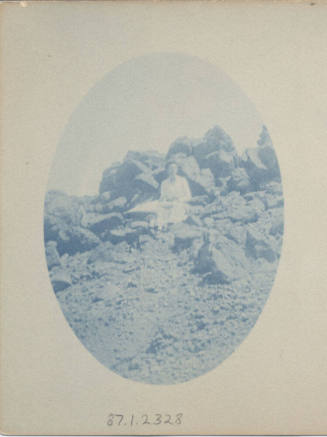 Unidentified Women Sitting on a Rock