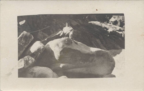 Photograph of a Lady Sitting on a Rock