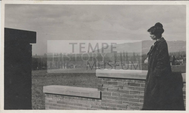 Unidentified Woman Standing Next to Wall