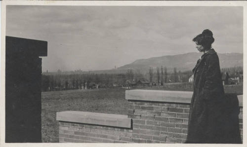 Unidentified Woman Standing Next to Wall