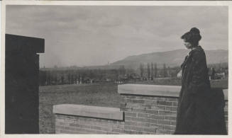 Unidentified Woman Standing Next to Wall