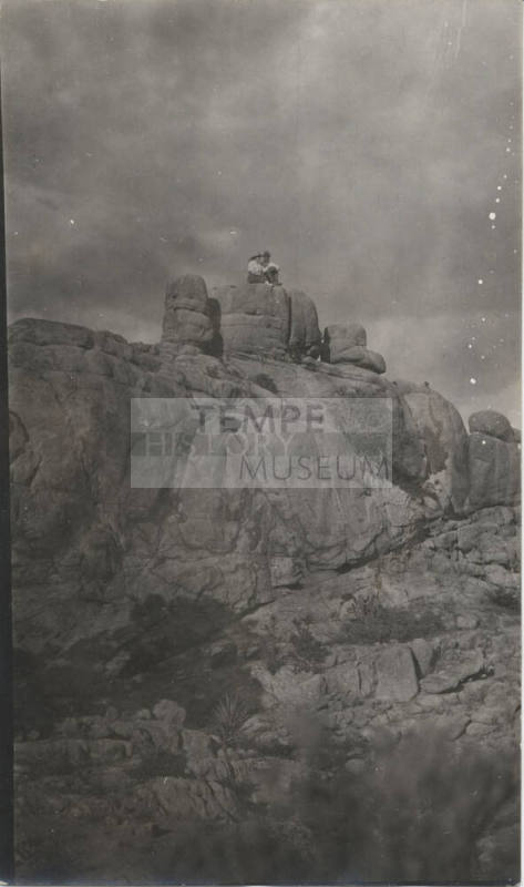 People Sitting on a Rock Formation