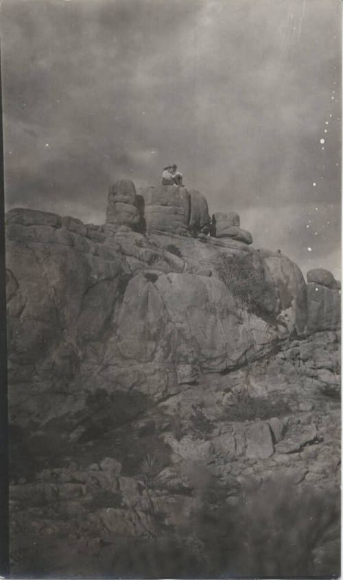 People Sitting on a Rock Formation