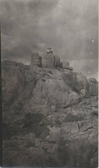 People Sitting on a Rock Formation