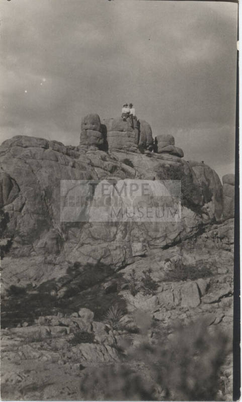 People Sitting on a Rock Formation
