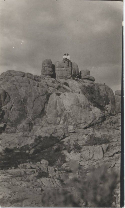People Sitting on a Rock Formation