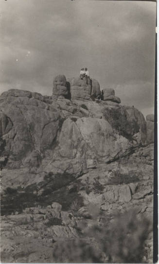People Sitting on a Rock Formation
